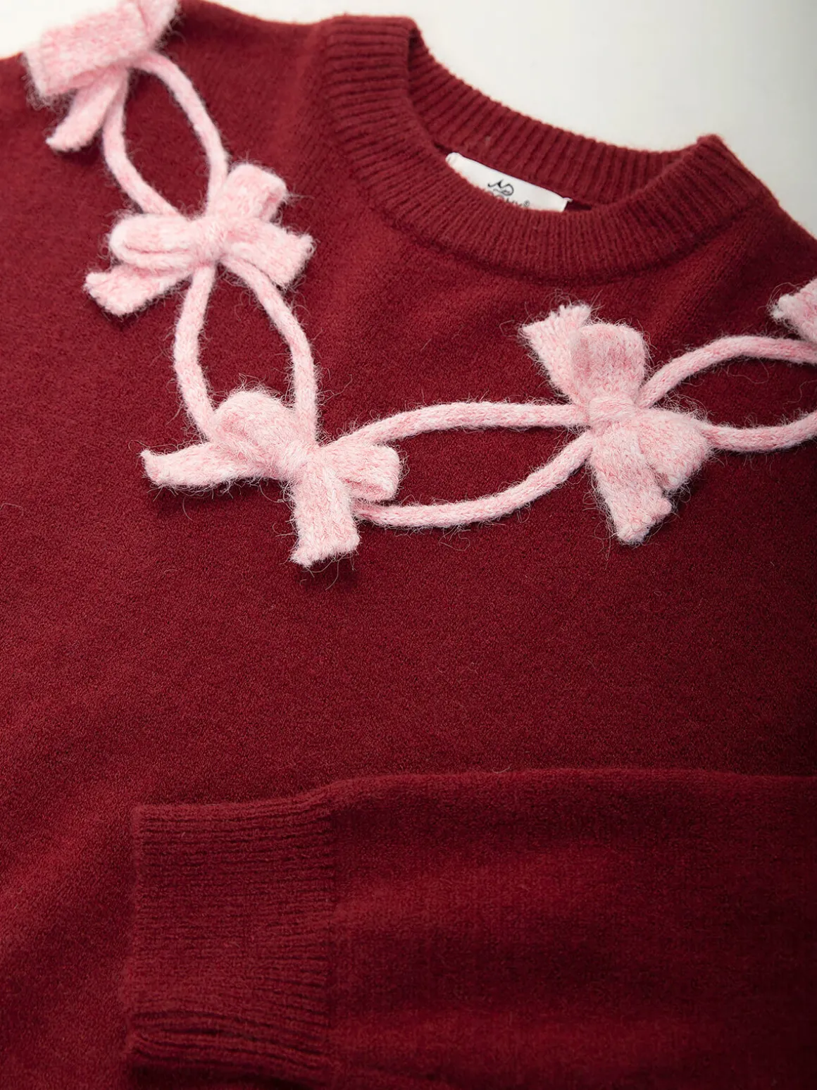 Camisola malha com laços aplicados